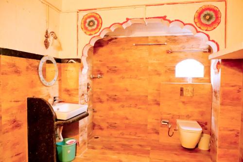 a bathroom with a toilet and a sink at Singhvi's Haveli in Jodhpur