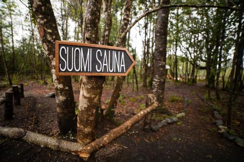 a sign on a tree in a forest at La Escondida Pucon in Pucón