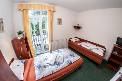 a bedroom with two beds and a window at Svycarska Bouda in Špindlerův Mlýn