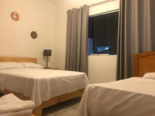 Postel nebo postele na pokoji v ubytování Hotel Tumpis