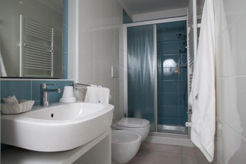a bathroom with a sink and a toilet and a shower at Hotel Albatros 3 Stelle Superior in Lido di Jesolo