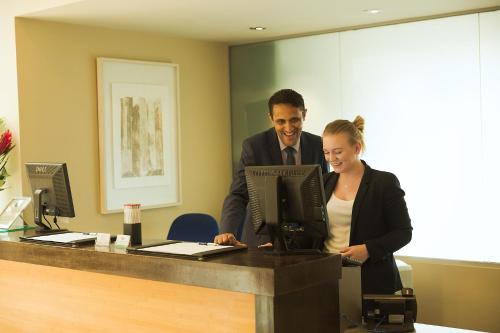 a man and a woman standing at a desk at Hart's Hotel in Nottingham