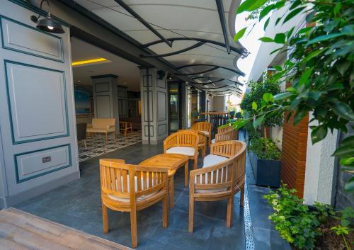 a row of wooden chairs and tables on a patio at Marmaris Beach Hotel in Marmaris