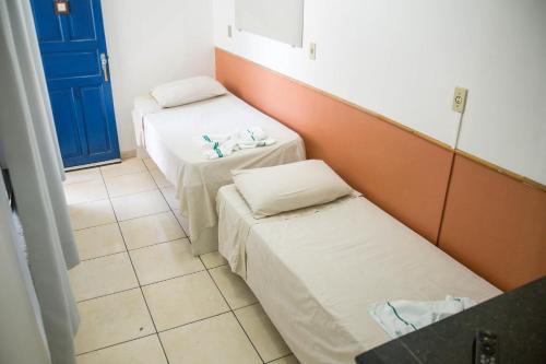 Postelja oz. postelje v sobi nastanitve Pousada Rio Branco Nova Lima - By UP Hotel