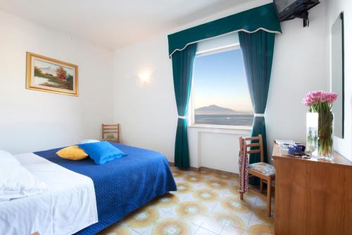 Säng eller sängar i ett rum på Hotel Settimo Cielo