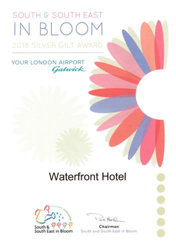 a flyer for a water front hotel with a colorful flower at Waterfront Hotel in Deal