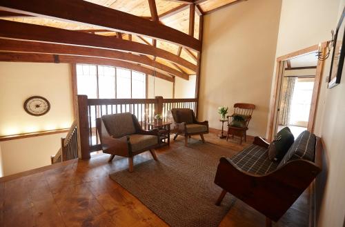 a living room with chairs and a table at Seesaw's Lodge in Peru