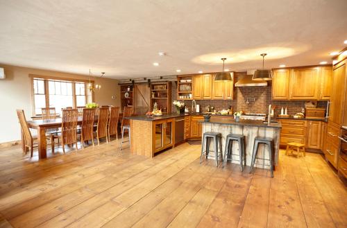 a large kitchen with wooden cabinets and a dining room at Seesaw's Lodge in Peru