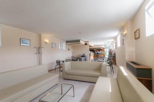 a living room with a couch and a table at Hotel Lido in Gargnano
