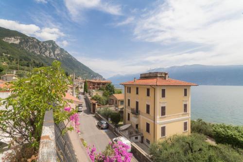 a view of a town next to the water at Hotel Lido in Gargnano