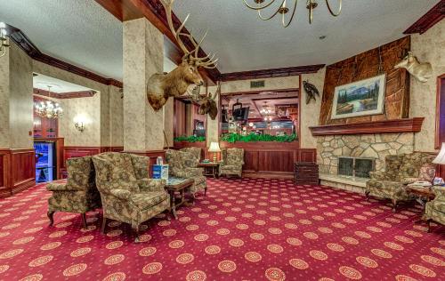 a living room filled with furniture and decor at Athabasca Hotel in Jasper
