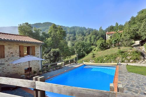 a swimming pool in front of a house at Mas Companyo - Vallespir - Céret - Grand Mas in Céret