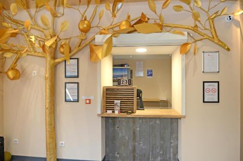 an office with a fake tree on the wall at Logis Hotel Yseria - Historical Center in Agde