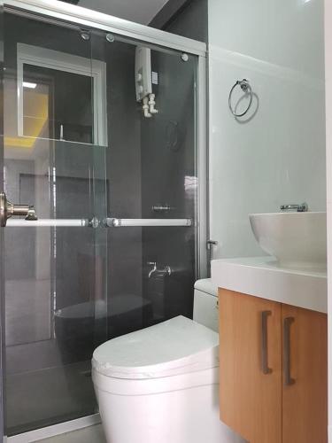 a bathroom with a shower and a toilet and a sink at *3BR/*3Bath Fully Furnished Town House - BICOL in Naga