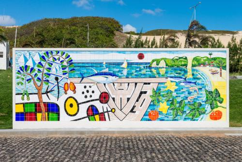 a mural on the side of a wall at Hotel Senac Barreira Roxa in Natal