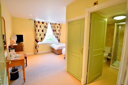 a room with a bedroom with a bed and a window at The Angel Hotel in Coleford