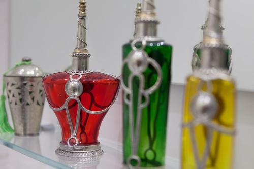 a group of glass bottles sitting on a glass shelf at Boutique House Fiò in Ischia
