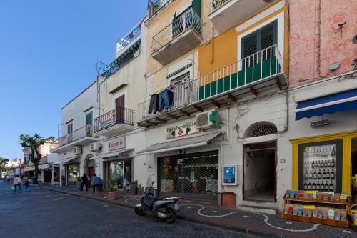 a street with a scooter parked in front of a building at Boutique House Fiò in Ischia