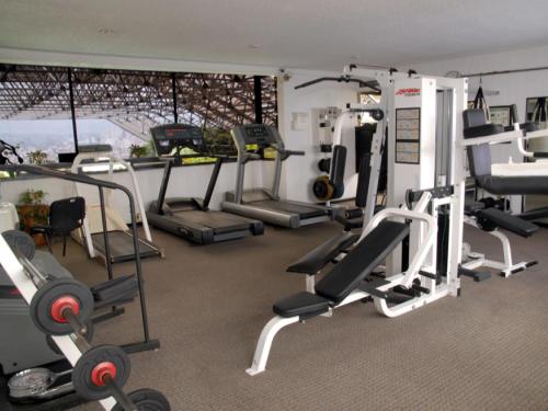 a gym with several tread machines in a room at Sevilla Palace in Mexico City