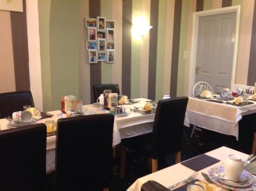a dining room with a table with food on it at Sherwood Lodge in Skegness