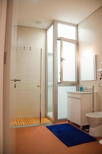 a bathroom with a shower and a toilet and a sink at Banho de Mar in Póvoa de Varzim