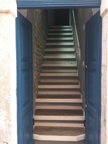 a stairway with blue doors and stairs in a building at Suite 30 mq in Palo del Colle
