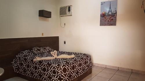 a person laying on a bed in a room at Costa Miramar in Acapulco