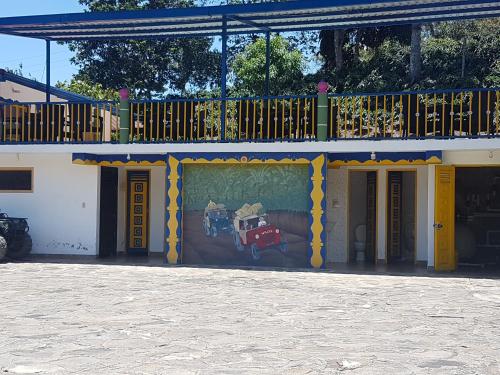 a building with a painting on the side of it at Finca Hotel Guayacundo in Vergara