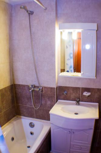 a bathroom with a sink and a shower with a mirror at Hotel San Remo Majestic in Mar de Ajó