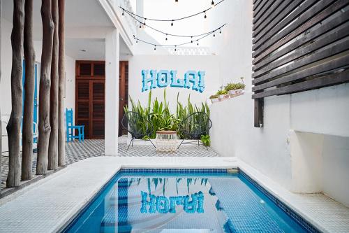 a swimming pool with blue graffiti on the side of a house at Casa el Pio in Isla Mujeres