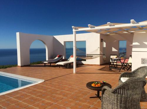 a house with a patio with a swimming pool at Cerro del Pozo in Adra