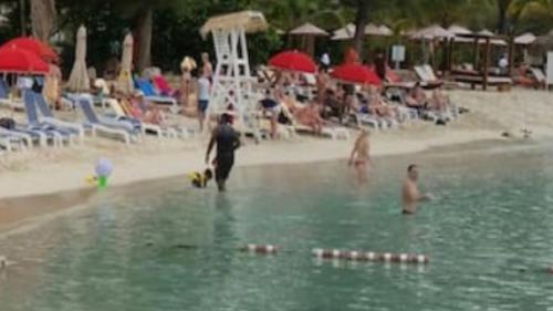 a group of people in the water at a beach at Beryls at Seawind on the Bay , Montego Bay , Jamaica in Montego Bay
