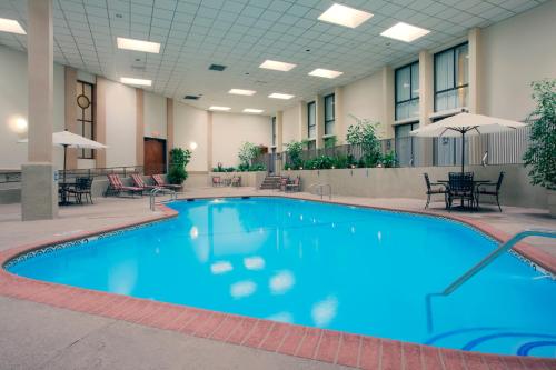 a large swimming pool in a hotel room at Wyndham Visalia in Visalia