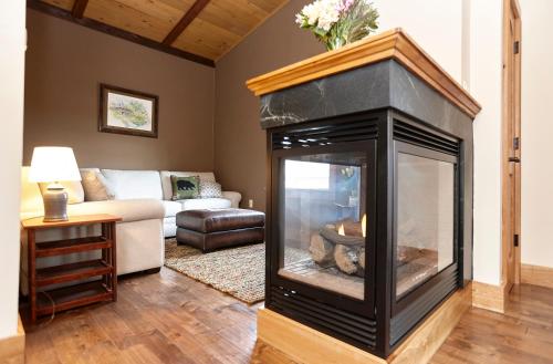 a fireplace in a living room with a couch at Seesaw's Lodge in Peru