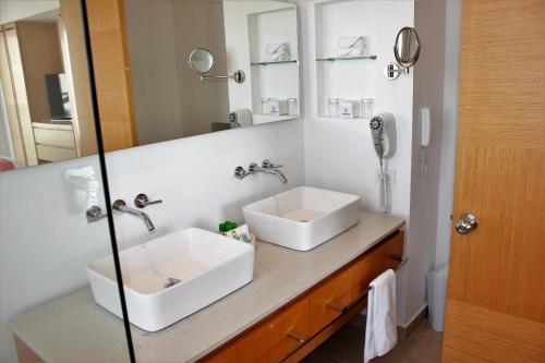 a bathroom with a white sink and a mirror at Hotel Irotama Reservado in Santa Marta