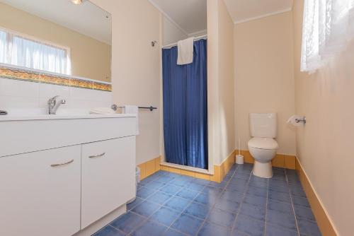 a bathroom with a sink and a toilet at Blue Lake TOP 10 Holiday Park in Rotorua