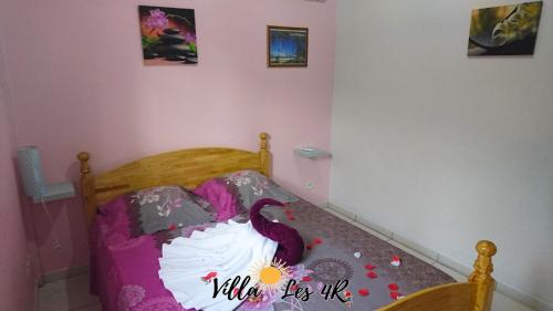 a bedroom with a bed with a cake on it at Villa les 4R in Les Abymes