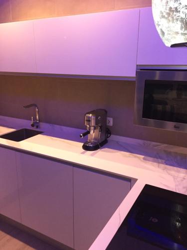 a kitchen with purple lighting on a counter at Premium Apartment Yumbo WIFI A/C in Playa del Ingles