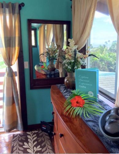 a dresser with a mirror on top of it at Kalani Hawaii Private Lodging in Pupukea
