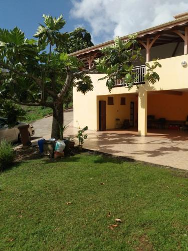 a house with a yard in front of it at Le Nid De Nicolas in Saint Esprit