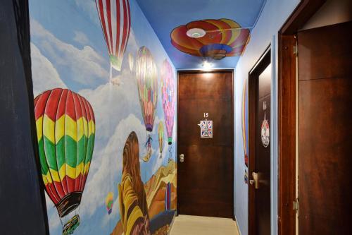 a hallway with a painting of hot air balloons at International House Co-Living in Medellín