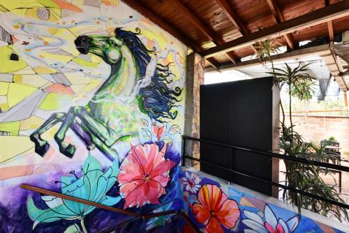 a painting of a horse on a wall at International House Co-Living in Medellín