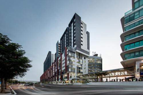 a street with tall buildings in a city at The Canvas Hotel in Klang