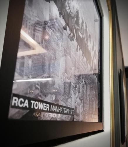 a poster of a rca tower mountain on a wall at The Loft Plaza Hotel in Bangi