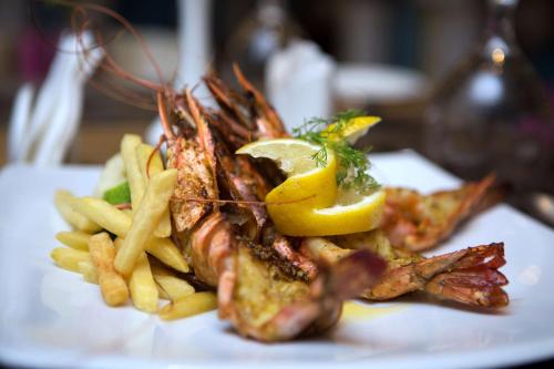 a plate of food with shrimp and french fries at Best Western Plus Pearl Creek in Dubai