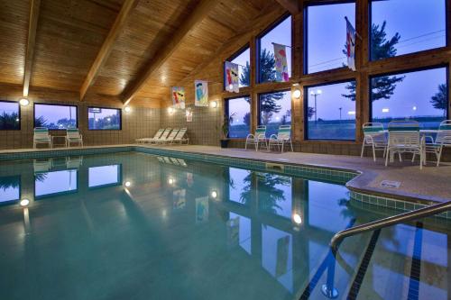 a swimming pool in a house with windows at AmericInn by Wyndham Grundy Center in Grundy Center