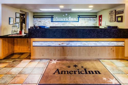 a restaurant with a counter with an american sign on it at AmericInn by Wyndham Hampton in Hampton