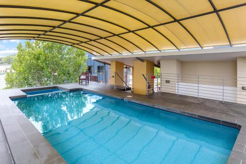 an indoor swimming pool with a retractable ceiling at Nesuto Chippendale in Sydney