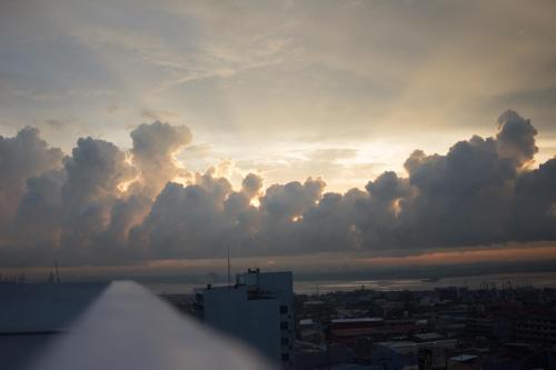 a view of a sunset with clouds in the sky at One Central Hotel & Suites in Cebu City