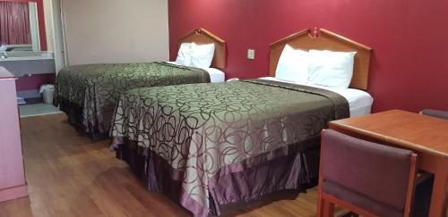 Katil atau katil-katil dalam bilik di Deluxe Inn